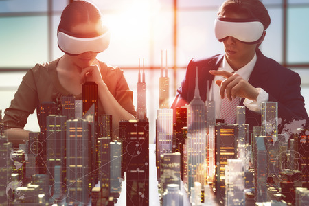 54018554 - two business persons are developing a project using virtual reality goggles. the concept of technologies of the future